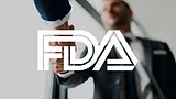 Business people shaking hands with FDA logo overlay