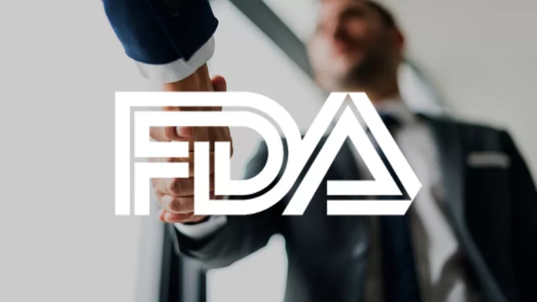 Business people shaking hands with FDA logo overlay