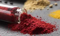 Image of container spilling red powder