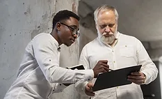 Two food safety inspectors consulting with each other