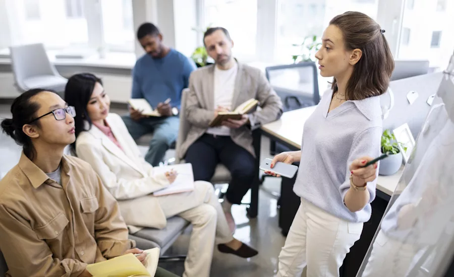 Manager leading training session for group of employees