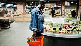 man in grocery store produce section