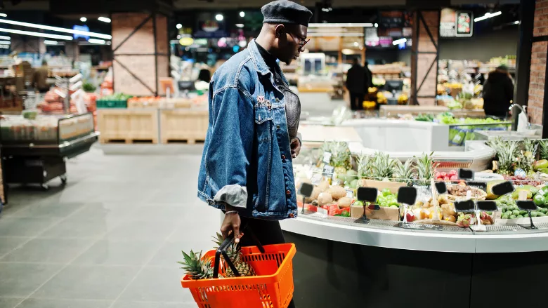 man in grocery store produce section