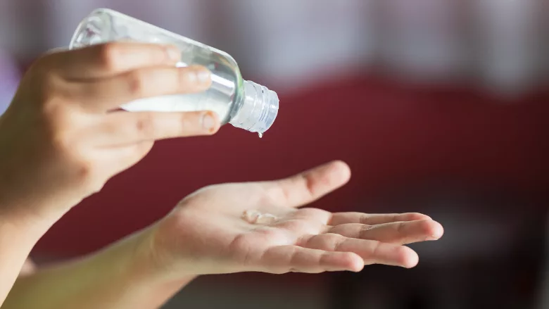 person applying hand sanitizer