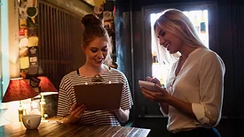 waitress discussing menu with customer