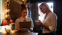 waitress discussing menu with customer waitress discussing menu with customer