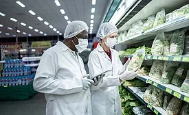 epidemiologists or scientists in white lab coats and masks and hairnets in a grocery store investigating lettuce