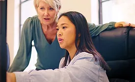 two women discussing something they see on the computer