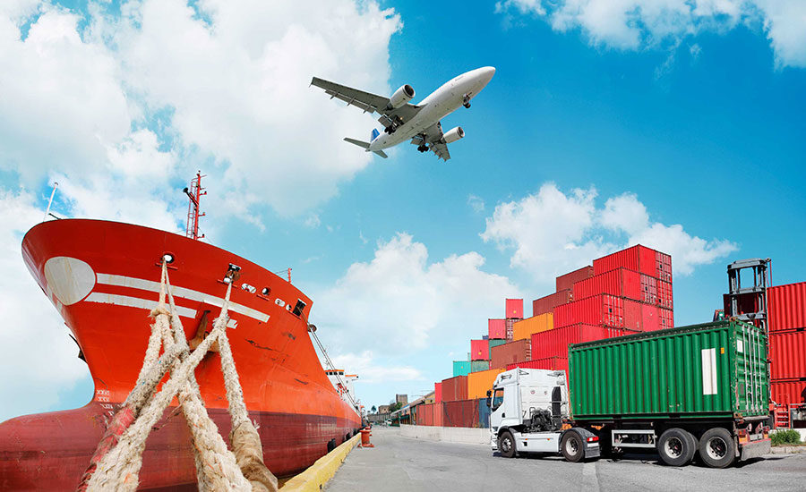 plane flying over ship and containers