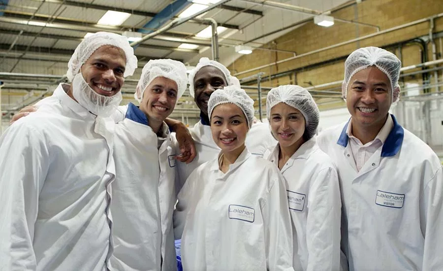 a group of workers wearing hair nets