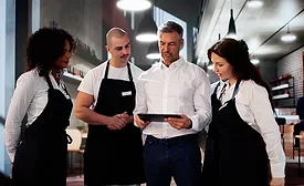 restaurant manager talking to servers