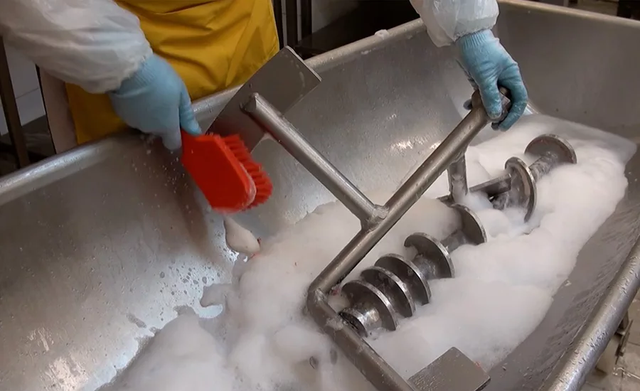 man washing equipment