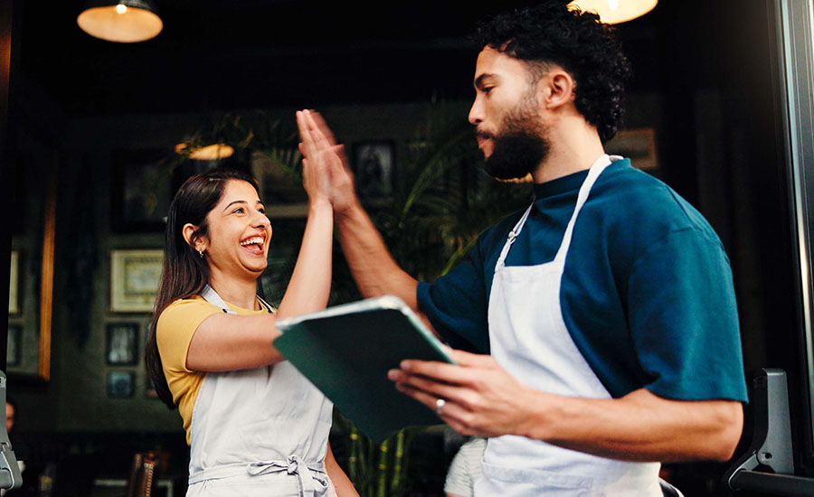 restaurant workers high fiving