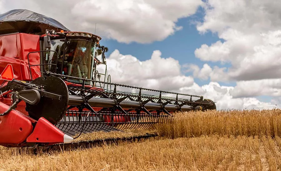 The image shows a combine harvester, which is a machine used to harvest a variety of cultivated seeds. The image shows a combine harvester, which is a machine used to harvest a variety of cultivated seeds.