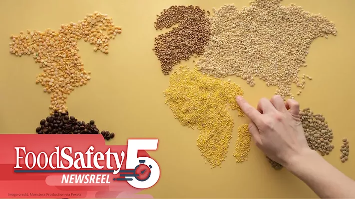 The image depicts a world map created from various types of grains, cereals, and coffee beans. 