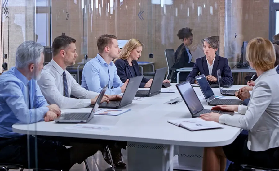 a professional business team engaged in a corporate meeting around a conference table in a modern office