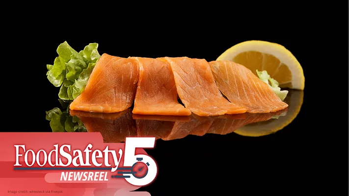 The image displays smoked salmon slices paired with lettuce and a lemon wedge