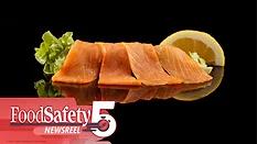 The image displays smoked salmon slices paired with lettuce and a lemon wedge