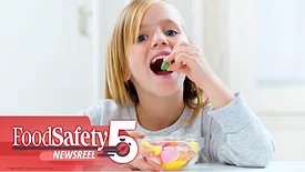 This image shows a person enjoying candy, with branding for "FoodSafety Newsreel" in the corner.
