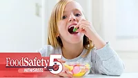 This image shows a person enjoying candy, with branding for "FoodSafety Newsreel" in the corner. This image shows a person enjoying candy, with branding for "FoodSafety Newsreel" in the corner.