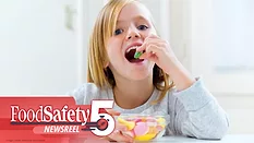 This image shows a person enjoying candy, with branding for "FoodSafety Newsreel" in the corner.