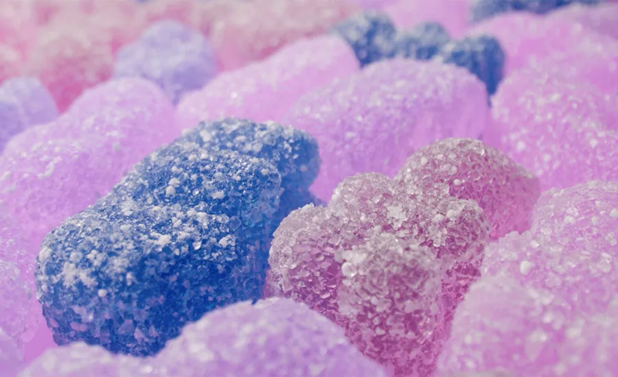 This image shows a close-up texture background of colorful jelly gummy bear candies. This image shows a close-up texture background of colorful jelly gummy bear candies.