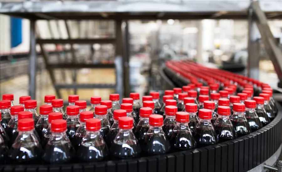 The image displays a bottling plant production line, commonly used in the beverage industry for filling and packaging soft drinks. The image displays a bottling plant production line, commonly used in the beverage industry for filling and packaging soft drinks.