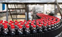 The image displays a bottling plant production line, commonly used in the beverage industry for filling and packaging soft drinks. 