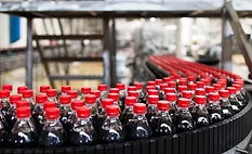 The image displays a bottling plant production line, commonly used in the beverage industry for filling and packaging soft drinks. 