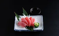 a plate of tuna sashimi, featuring sliced raw fatty tuna a plate of tuna sashimi, featuring sliced raw fatty tuna