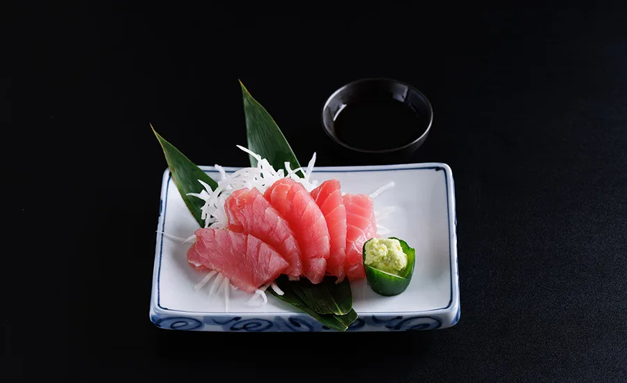 a plate of tuna sashimi, featuring sliced raw fatty tuna