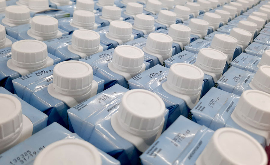 closely packed rows of blue and white liquid cartons