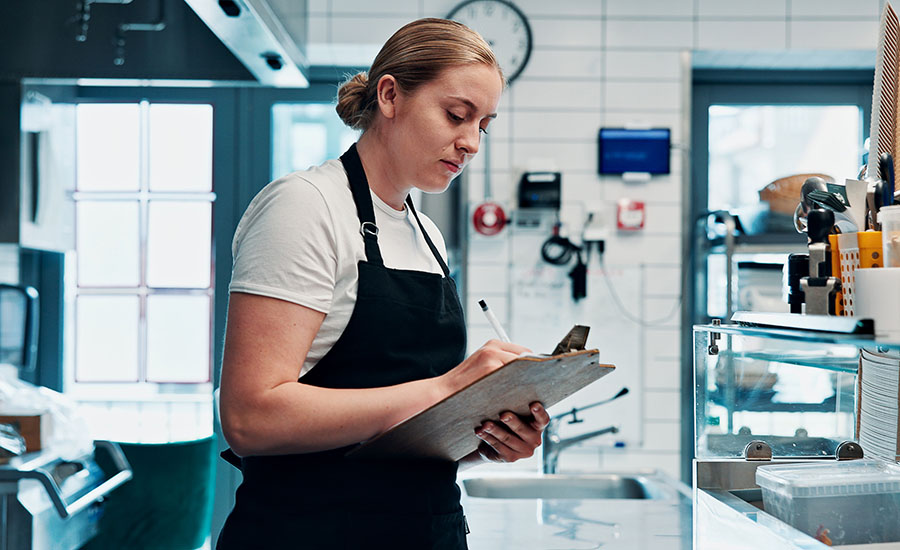 a person focused on their work in a commercial kitchen setting