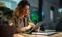 a person using a tablet computer in a professional setting a person using a tablet computer in a professional setting
