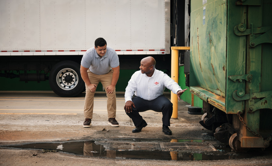 An Orkin technician is inspecting the facility exterior