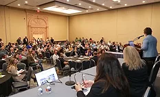 This image depicts a large professional conference or industry summit, commonly attended by experts for networking and educational sessions. 