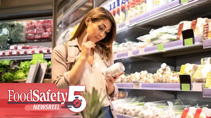 This image shows a person inspecting a food product while shopping in a supermarket. 