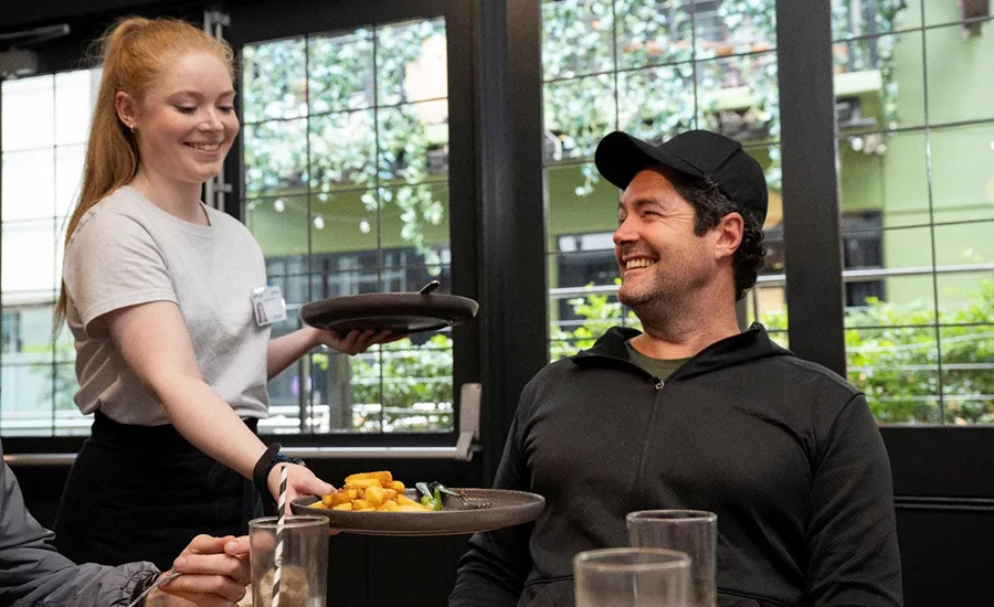a server providing dining service to a customer