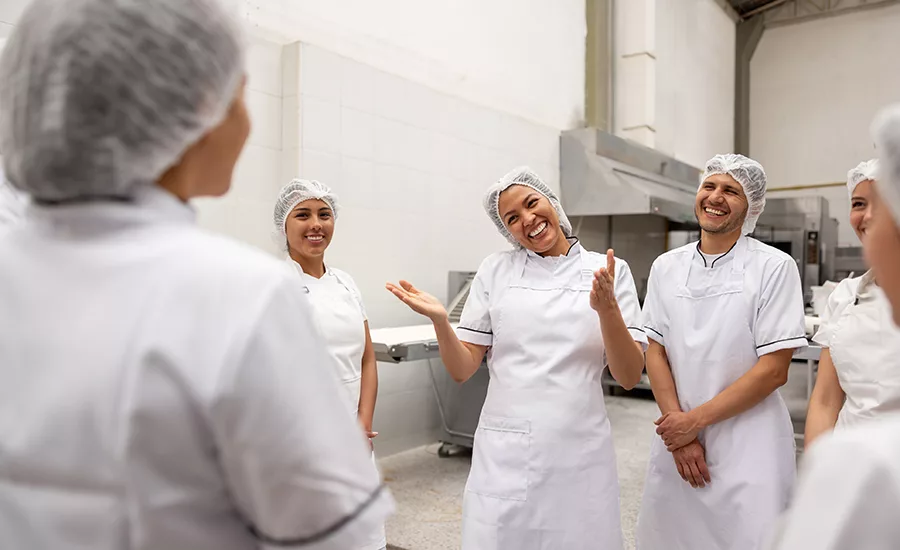 a group of workers in a food production facility a group of workers in a food production facility