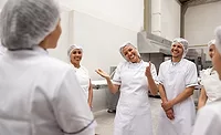 a group of workers in a food production facility a group of workers in a food production facility
