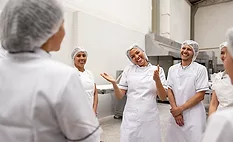 a group of workers in a food production facility