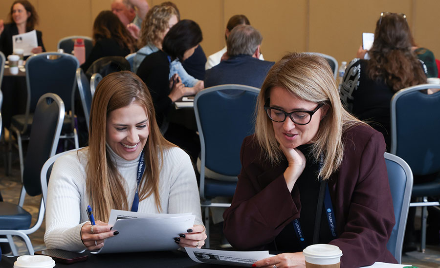 Katie Marquardt (left, in white) and a colleague participating in a workshop session during the Fluke Leadership Summit