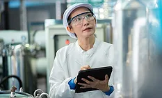a quality assurance technician or food safety worker in protective gear