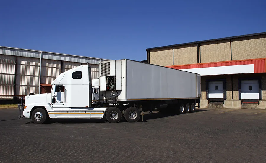 Semi-truck making a delivery at a frozen goods warehouse Semi-truck making a delivery at a frozen goods warehouse