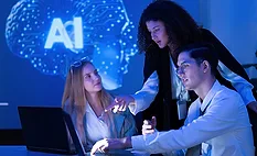 hree people collaborating in front of a laptop with an "AI" brain graphic in the background. hree people collaborating in front of a laptop with an "AI" brain graphic in the background.