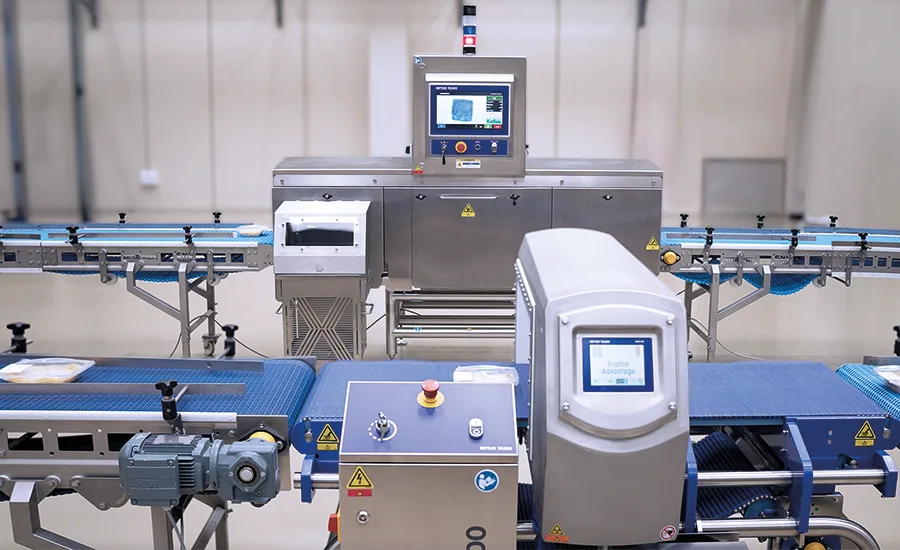 a conveyorized industrial metal detector system that appears to resemble a Loma Systems IQ4 Metal Detector setup with an integrated conveyor belt and control panel for food or package inspection. a conveyorized industrial metal detector system that appears to resemble a Loma Systems IQ4 Metal Detector setup with an integrated conveyor belt and control panel for food or package inspection.