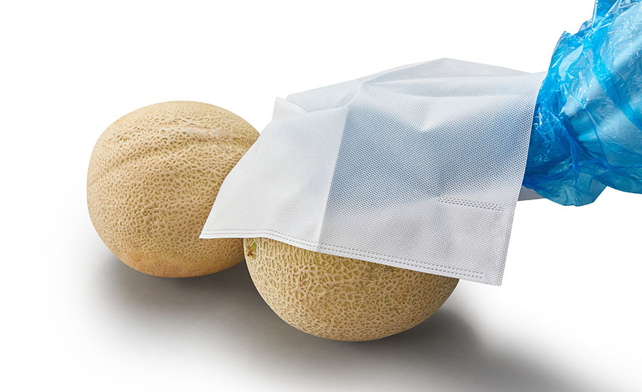 cantaloupes alongside a textured white cleaning cloth or wrapper