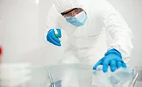 person in PPE sanitizing surfaces person in PPE sanitizing surfaces