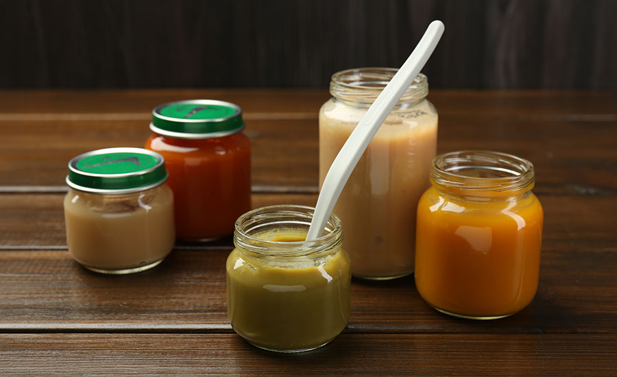 Several jars of different colored baby food