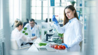 woman testing tomatoes in a science lab.jpg